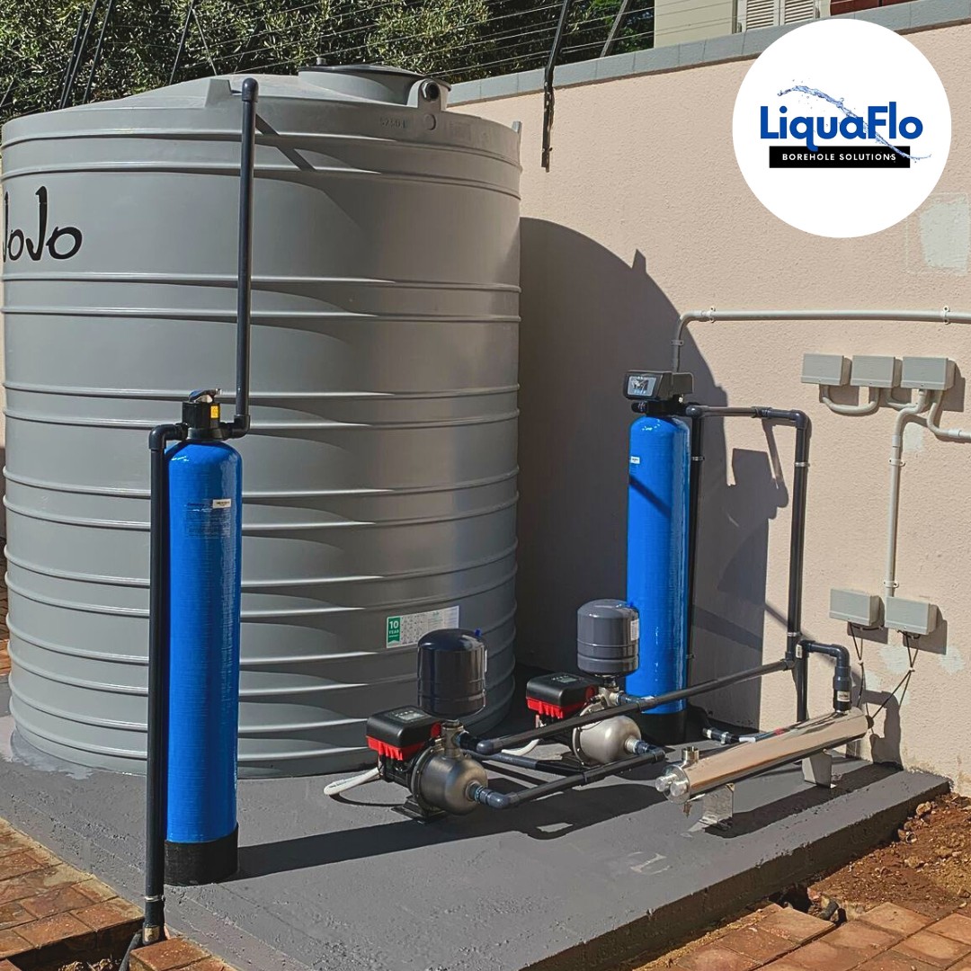 Fully installed borehole water system with storage tank, filtration columns, and pressure pumps for reliable off-grid water supply