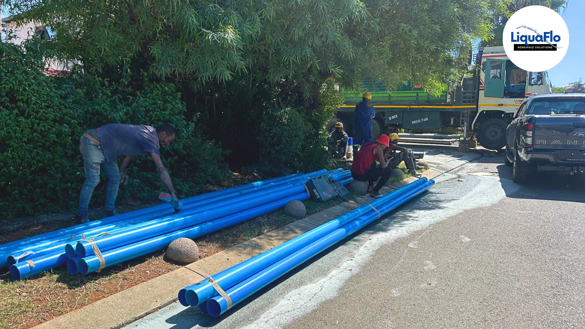 LiquaFlo technicians preparing blue water pipes for borehole system installation, ensuring SABS approved quality for water supply