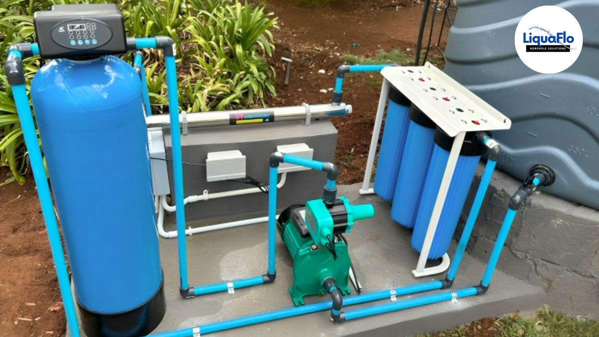 Comprehensive borehole water filtration system with blue pressure tank, filtration modules, and green pump installed by LiquaFlo.